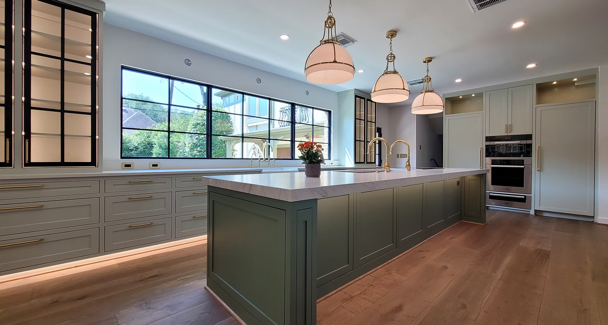 Kitchen with island, pendant lights and wide windows